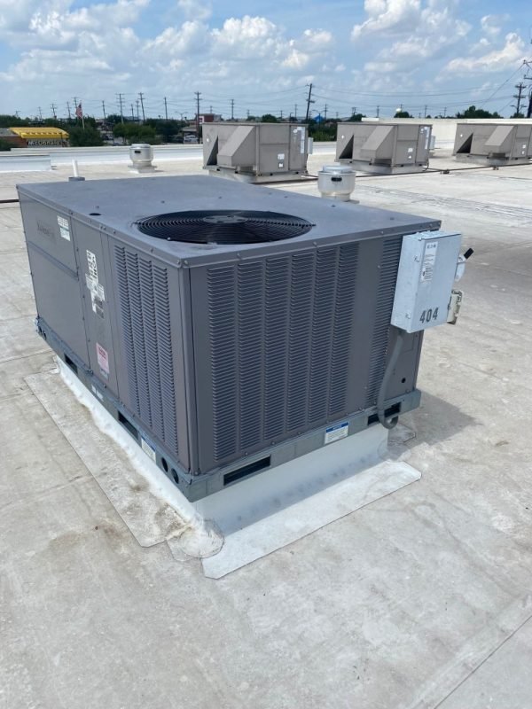 Commercial rooftop packaged HVAC unit on a white membrane roof